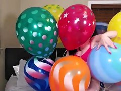 Playing young milf having fun with balloons on the bed