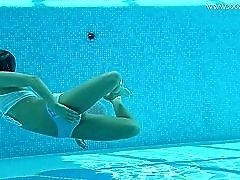 Swimming skinny chick strips naked in the pool