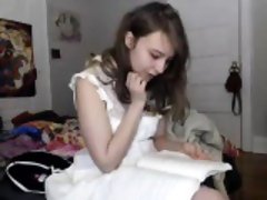 Sexy little brunette gets dressed and reads on her live web